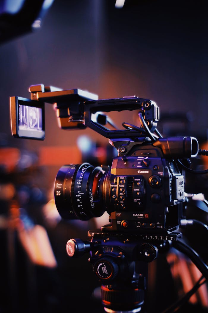 Close-up of a professional video camera setup indoors, capturing high-quality footage.